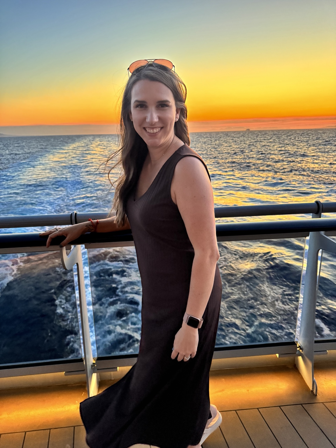 Chrissy Couture smiling on a cruise ship balcony at sunset